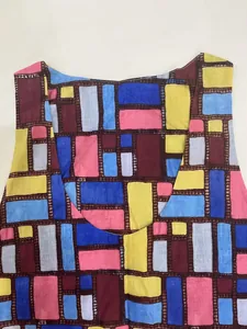 Close-up of colorful irregular geometric print on women's loose round neck dress