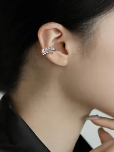 Close-up of a sparkling silver wheat ear leaf cuff earring with marquise cubic zirconia.
