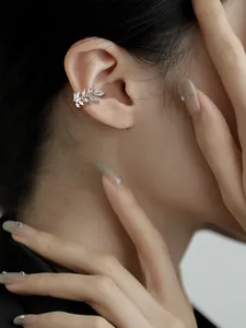 Detailed view of a sparkling leaf-shaped ear cuff with marquise-cut zircons