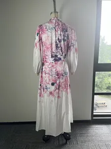 Rear view of a stylish pink floral print long-sleeve maxi shirt dress on a mannequin.