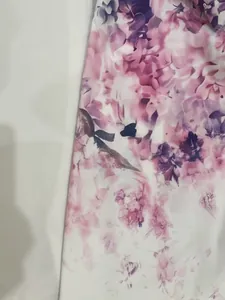 Detailed macro view showing the elegant purple and pink floral pattern on dress fabric