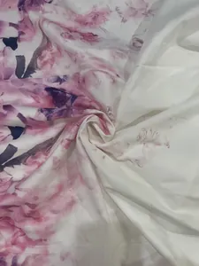 Macro view of elegant pink floral pattern on soft white fabric for women's dress