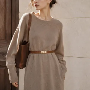 Detailed view of a cozy beige knit sweater dress accessorized with a slim brown belt