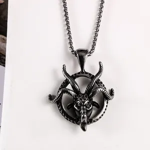 Detailed view of vintage stainless steel goat head pendant with carved ring.