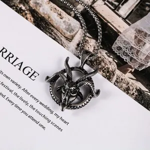 Close-up detail of vintage stainless steel goat head pendant necklace for men