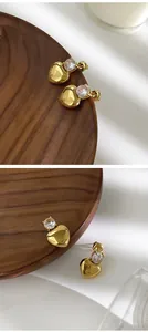 Close-up of elegant gold-plated heart earrings featuring sparkling cubic zirconia stones