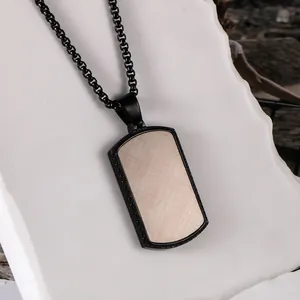 Detailed view of a men's black square pendant necklace with textured wood grain inlay.