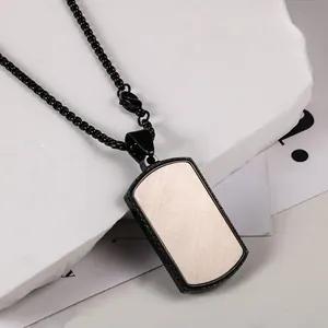 Detail view of men's fashionable square black dog tag necklace with wood grain inlay