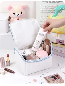 Detailed view of white padded makeup bag showing interior storage capacity and cosmetics
