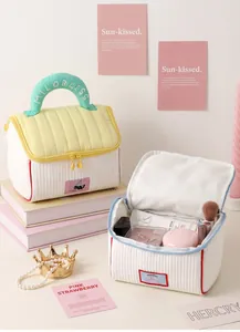 Padded house-shaped cosmetic bag showing open storage for makeup and brushes