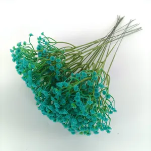 Close-up of turquoise artificial gypsophila baby's breath bundle for wedding decor.