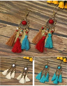 Handmade vintage Bohemian long tassel drop earrings with ethnic bead and leaf detail