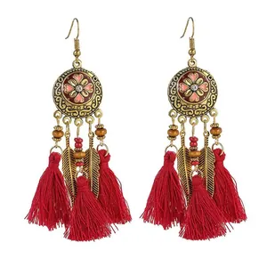 Bohemian ethnic red tassel drop earrings with rhinestone accents and golden leaf charms.