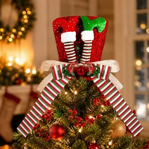 Close-up detail of sequined Christmas tree topper hat with elf legs and striped bow.