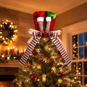 Detailed view of red sequin Christmas tree topper with elf legs and striped bow