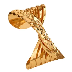 Exaggerated gold-plated twisted cross cuff bracelet with chunky irregular design