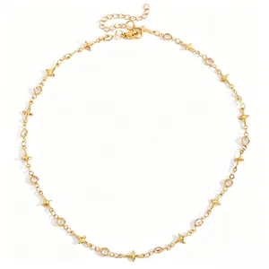 Vue détaillée d'un collier ras du cou doré avec étoiles à quatre branches et cristaux