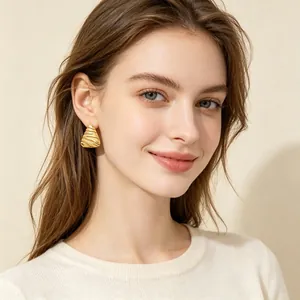 Vintage gold embossed triangle stud earring worn by model for elegant style