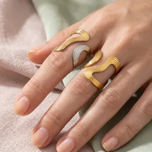 Elegant wavy irregular line rings in gold and silver finish worn on fingers for women