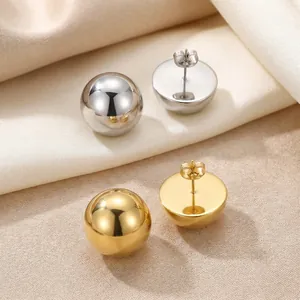 Detailed view of polished gold and silver stainless steel hemispherical stud earrings