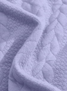 Detailed macro shot of lavender purple jacquard textured sweatshirt fabric