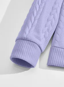 Detail shot of a purple jacquard textured sweatshirt sleeve featuring ribbed cuffs.