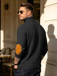 Detailed view of men's dark grey cable knit turtleneck sweater with tan elbow patches