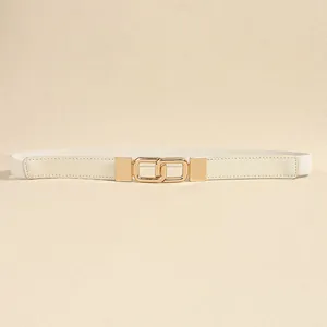 Detail view of a white women's elastic thin belt with a gold interlocking buckle