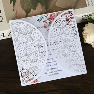 Elegant white laser-cut wedding invitation card with detailed floral patterns and printing