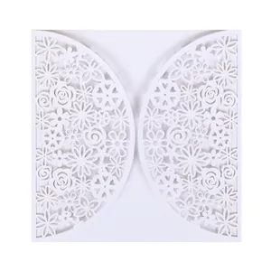 Detailed view of the intricate white laser-cut floral pattern on wedding invitation card.