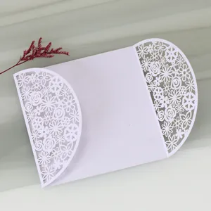 Elegant white laser-cut wedding invitation featuring intricate hollow floral design patterns