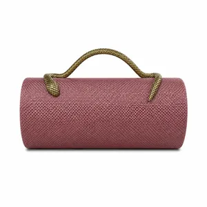 Detailed view of the pink woven PU evening bag with a unique gold snake handle
