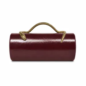 Close-up of the glossy burgundy PU leather texture and golden snake-shaped handle