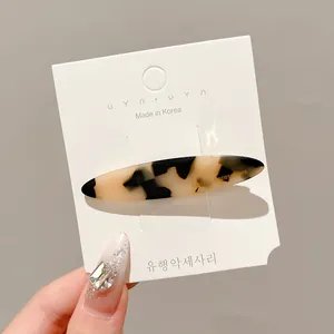 Tortoiseshell pattern oval hair clip on white display card