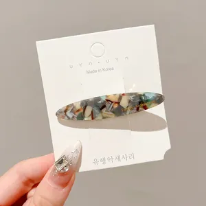Korean style colorful marble pattern resin duckbill hair clip on a white display card