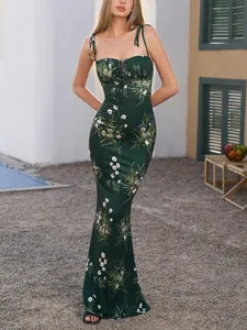 Slim dark green floral mermaid dress with tie straps and cutout front for vacation.