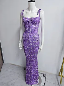 Elegant purple floral mermaid maxi dress with adjustable tie-straps on white mannequin