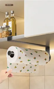 Under-cabinet black kitchen paper towel holder shown in use for easy access
