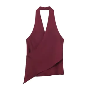 Exquisite detail of burgundy silk-like satin halter neck wrap top with asymmetric hem.