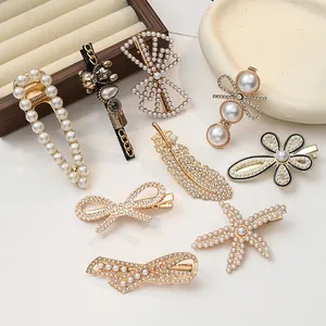Elegant set of pearl and rhinestone hair clips featuring vintage bear and feather