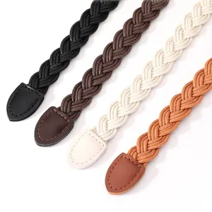 Detail of four braided women's belts in different colors with faux leather ends.
