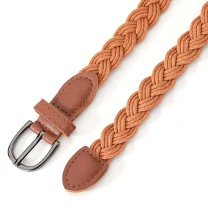 Detailed macro view of a caramel brown braided belt for women with elegant buckle