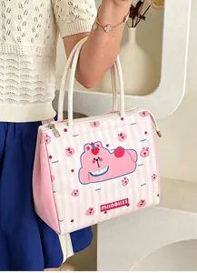 Detail shot of a cute pink striped insulated lunch bag being carried by hand