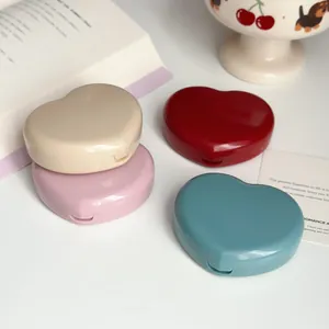 Detailed shot of four cute heart-shaped contact lens cases in vibrant candy colors