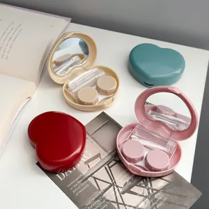 Candy-colored heart-shaped contact lens case with a built-in mirror and care tools