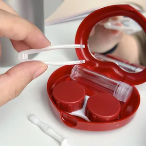 Red heart-shaped contact lens case set with internal mirror, storage pots, and tweezers