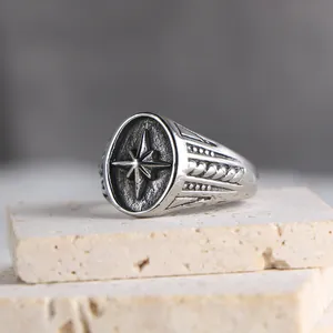 Vintage stainless steel signet ring for men featuring a detailed carved compass star design
