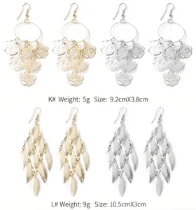Detailed view of long metal dangle earrings in flower and leaf tassel designs