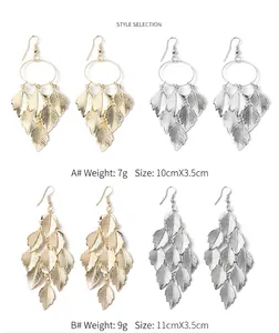Close-up detail of leaf-shaped tassel drop earrings in gold and silver color finishes