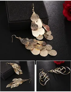 Stylish gold dangling earrings featuring teardrop sequins, leaf cutouts, and elegant spiral patterns.